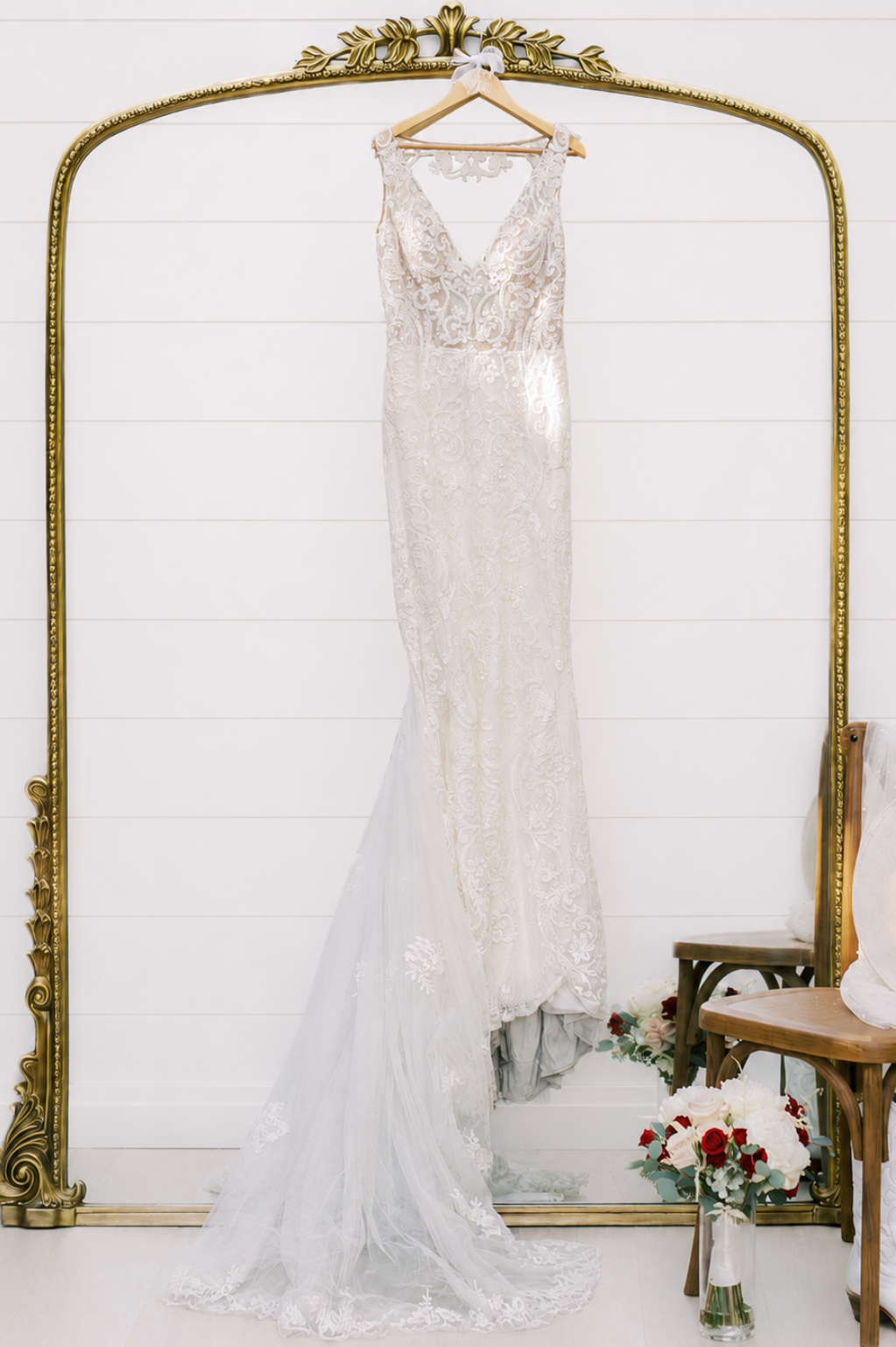 wedding dress hanging above a mirror